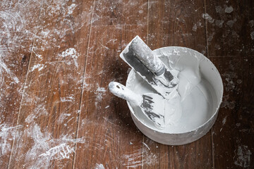 Applying decorative putty. White abstract texture of surface covered with putty. textured...