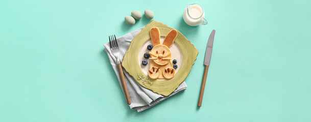 Funny Easter bunny pancakes with blueberry on turquoise background