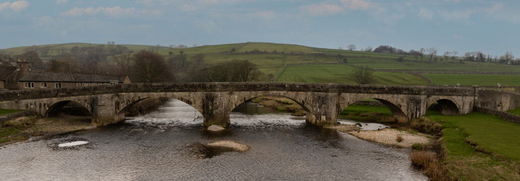 Aerial View of Burnsall bridge. One of the most beautiful villages in Wharfedale, Burnsall lies on a bend of the River Wharfe surrounded by a spectacular circle of fells.	