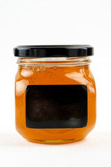 Jar of honey with nuts on white background