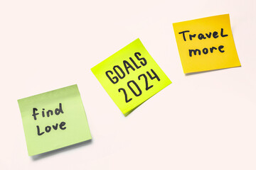 Sticky notes with different goals for 2024 on white background