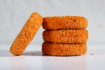 A stack of fried camembert on white background