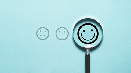 Smile face icon inside magnifier glass for customer excellent evaluation and feedback survey after use product and service concept.