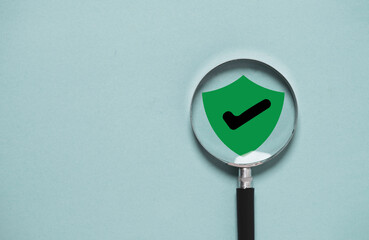 Green security safety with check mark icon inside of magnifier glass for focus cyber security and privacy in technology information data concept.