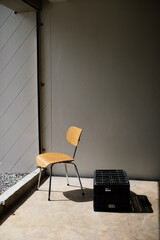 Wooden chairs and water crate bathed in sunlight.