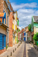 Amiens historical city centre Saint-Leu quarter with narrow street between colorful houses buildings with multicolored bright walls. France landmarks, Somme department, Hauts-de-France Region, France