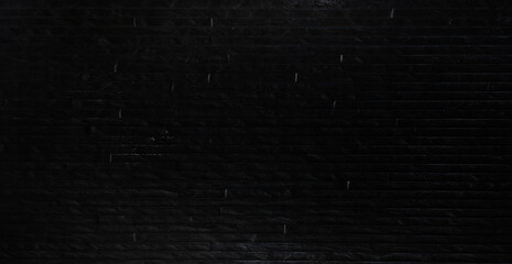 Panoramic background of wide black urban brick wall texture.