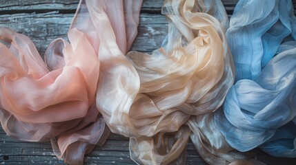 Elegant pastel-colored sheer scarves flowing gracefully on a rustic wooden background, exuding a soft and delicate texture. - obrazy, fototapety, plakaty