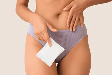 Zelfklevend Fotobehang Young woman in menstrual panties with pad on light background, closeup © Pixel-Shot