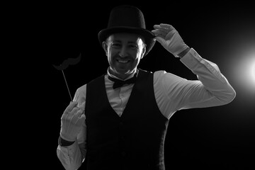 Silhouette of mature magician on dark background