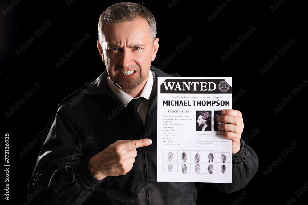 Sticker Angry mature FBI agent pointing at wanted poster on black background