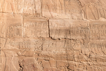 Macro extreme close up of Egyptian hieroglyphs carvings on a temple wall in Luxor Egypt.