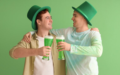 Young men with beer on green background. St. Patrick's Day celebration