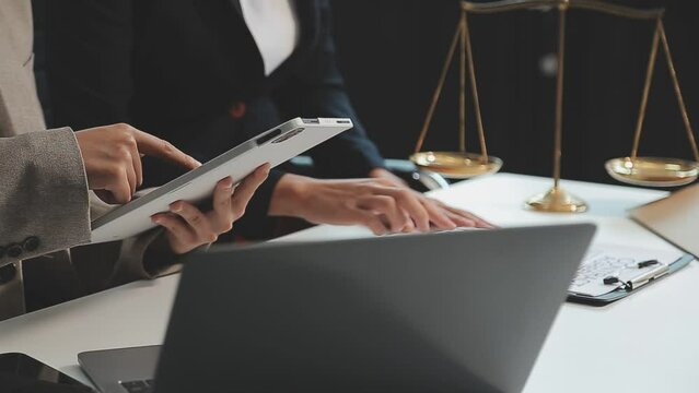 Business and lawyers discussing contract papers with brass scale on desk in office. Law, legal services, advice, justice and law concept picture with film grain effect