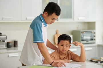 Confused school boy asking father to help with math homework - obrazy, fototapety, plakaty