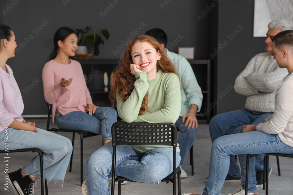 Canvas Prints Smiling young woman sitting at group therapy session