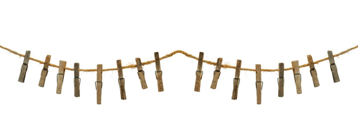 Old wooden clothespins, laundry hooks, on hemp rope, white background