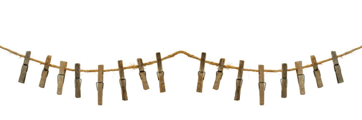 Old wooden clothespins, laundry hooks, on hemp rope, white background