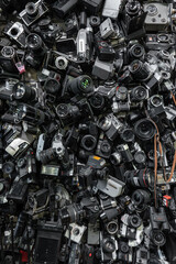 Fototapeta premium heap of old vintage film cameras and retro lenses, creative abstract photography and filmmaking background