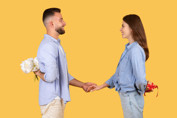 Man presenting flowers to woman on date