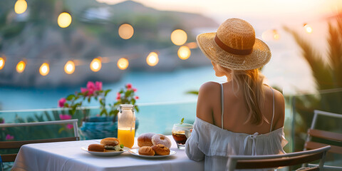 Woman having breakfast at outdoor cafe with amazing view on mykonos town. - obrazy, fototapety, plakaty