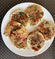 A circular-shaped Masala Uttapam is a South Indian dish that is often enjoyed as breakfast or...