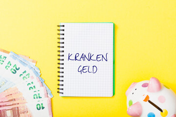 Krankengeld (German for sick pay) headline in notebook on yellow background