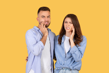 Man and woman with tooth pain expressions