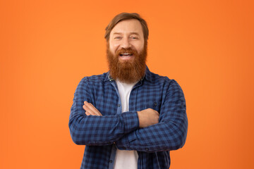 Portrait of funny European redhaired man with beard in glasses