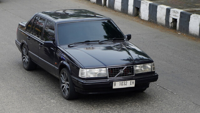 Black  old historical and  legendary sedan car, Volvo 960, drive at commercial area Gunung sahari Street Jakarta