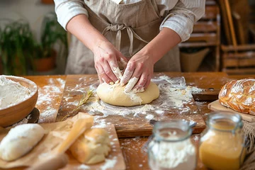 Foto op Canvas Baker kneads dough for bread at table in craft bakery shop closeup © zetrum