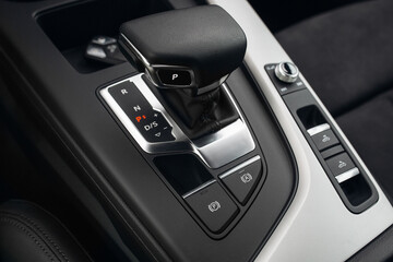 Modern and expensive car interior and gearbox shift handle  - obrazy, fototapety, plakaty