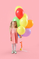Fototapeta na wymiar Happy smiling little girl with colorful balloons on pink background