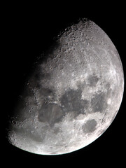 Illuminated moon image showcases a stunning lunar landscape with remarkable clarity and detail. The...