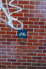 bike parking sign on the street with brick background