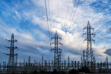 electrical substation and high voltage towers on a cloudy dayu - 772181512