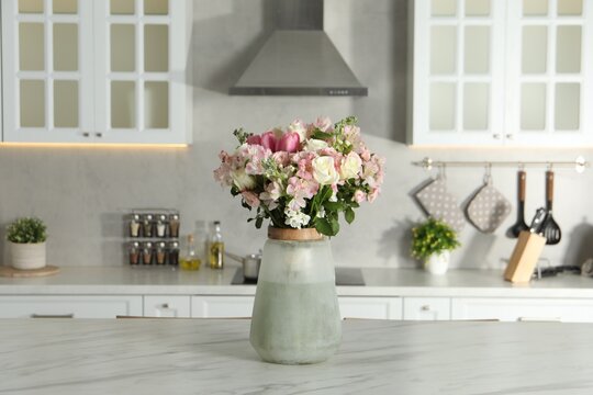 Beautiful bouquet of fresh flowers in vase on table indoors