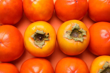 Delicious ripe juicy persimmons as background, top view