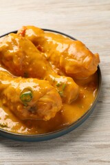 Tasty chicken curry on wooden table, closeup