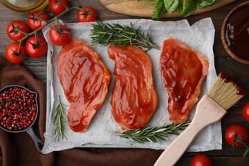 Flat lay composition with raw marinated meat, products and basting brush on wooden table