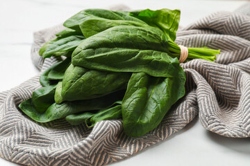 Bunch of fresh spinach leaves on white table, closeup