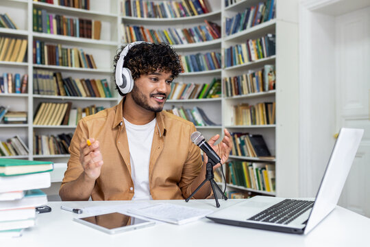 A passionate student immersed in recording a podcast session, surrounded by books in a library setting, conveying a vibe of knowledge and technology.