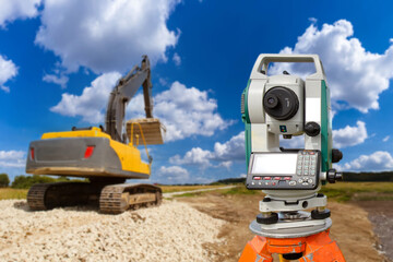 Geodetic instrument. Road construction. Surveyor apparatus on tripod. Crawler excavator. Geodetic...