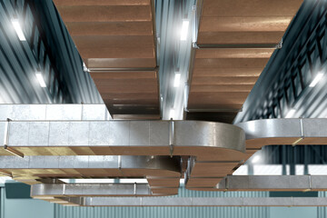 Ventilation system in warehouse. Steel square pipeline under roof. Ventilation under ceiling...