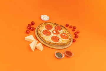 pizza with ingredients on orange background
