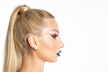 Fashion model woman with a bright make-up posing in studio