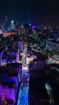 Night timelapse of downtown Ho Chi Minh City and the illuminated Bui Vien party street, Vietnam.