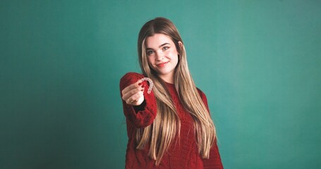 Smiling woman showing an invisible silicone aligner for dental correction