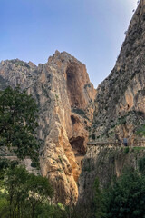 Fototapeta na wymiar Caminito del Ray, The King's Path. Walkway pinned along the steep walls of a narrow gorge in El Chorro, Malaga, Spain