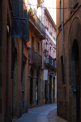 Fototapeta premium Sunlit alley in vic's historic center
